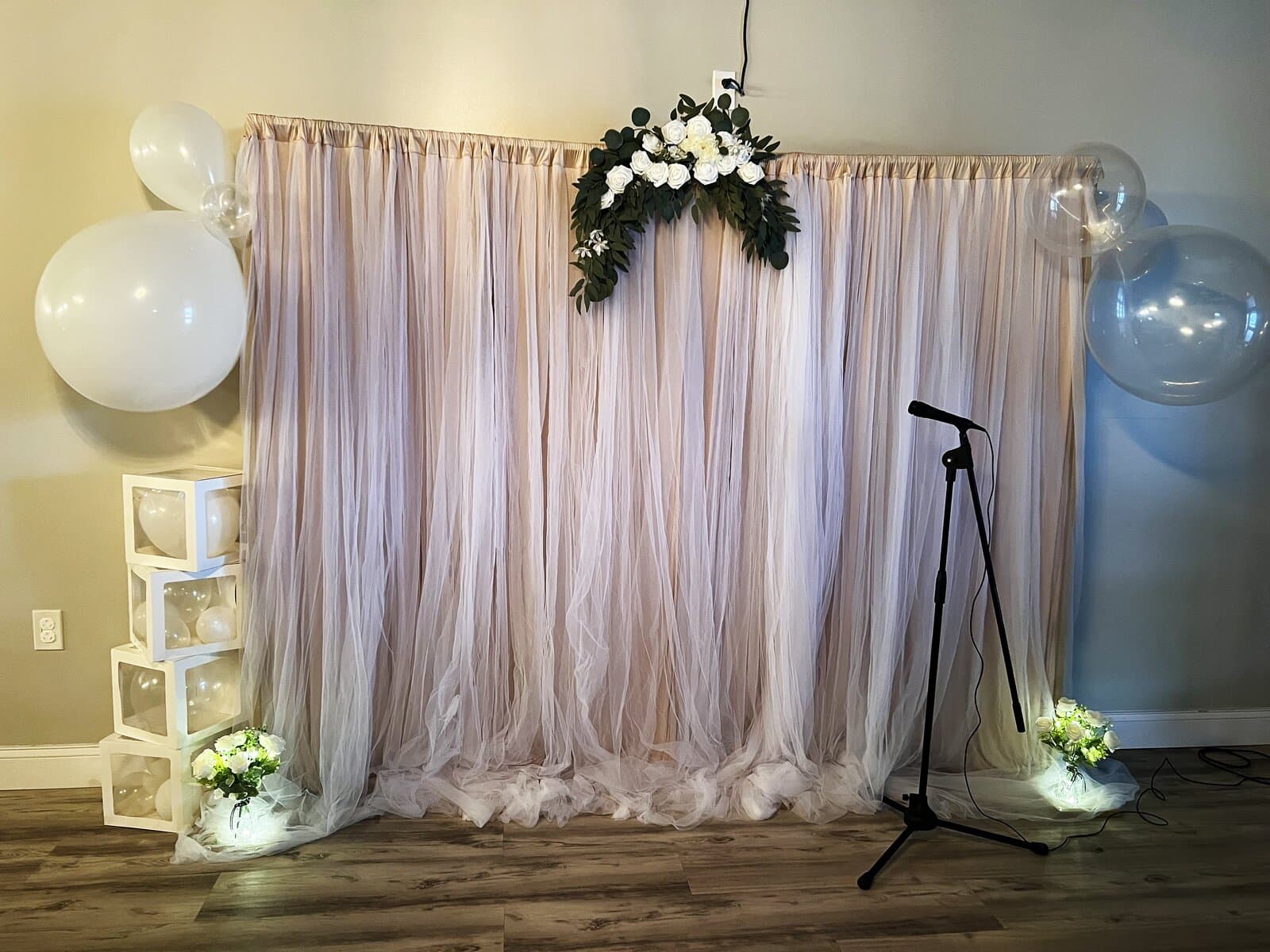 Blush ceremony backdrop with floral arrangement and balloons at LSC Event Space